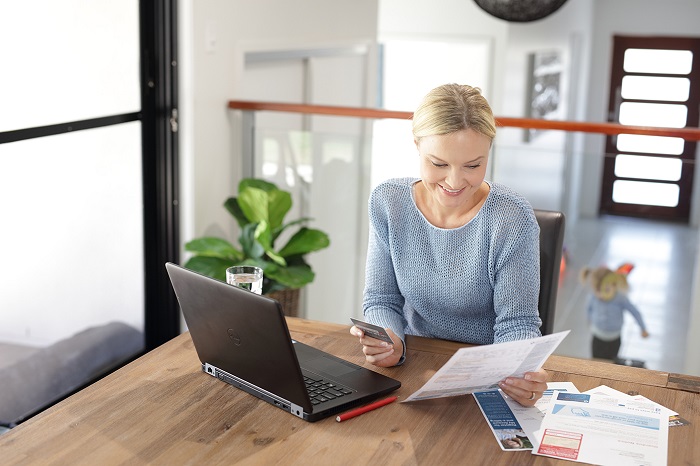 Woman setting up direct debit on laptop computer