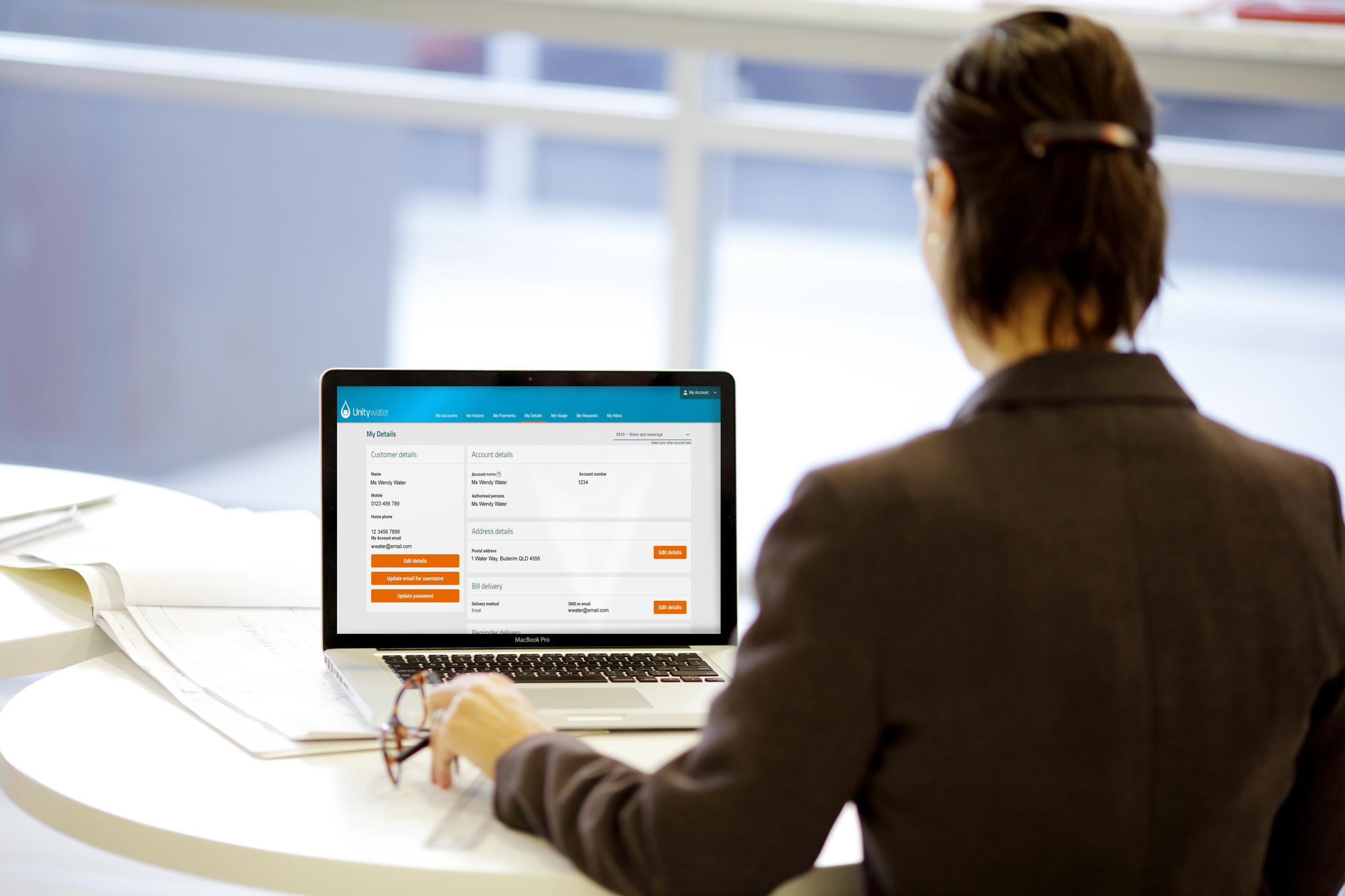 Business woman updating contact details on computer 2