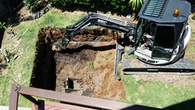 Excavator digging pool