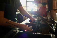 Barista washing dishes in cafe