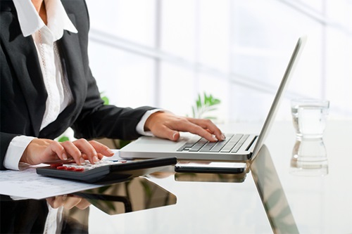 Female business person in office on laptop
