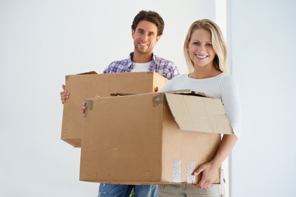 Young couple with moving boxes