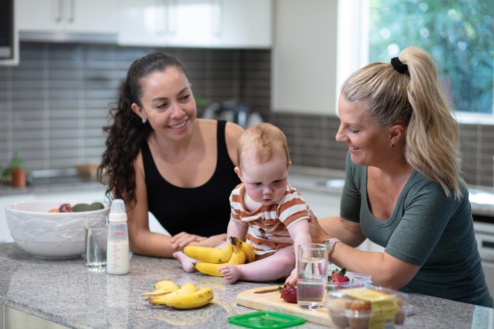 Two Unitywater customers with child at Kitchen bench