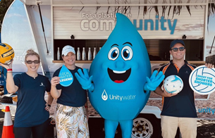 People standing with Unitywater mascot Wanda in front of Back to Tap van at Lightning game 2023