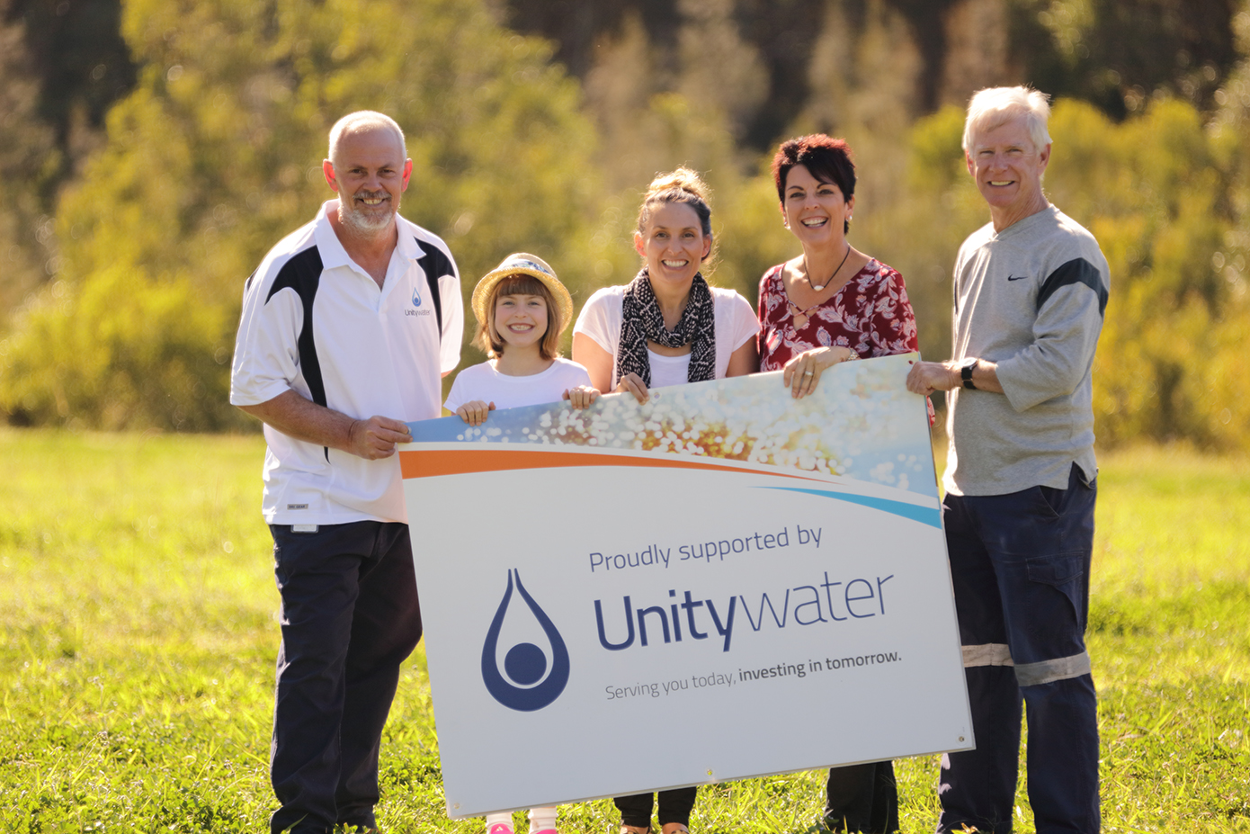 Group of people holding Unitywater sponsorship sign