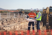 Certification and accreditation 2 men looking at maps on building site