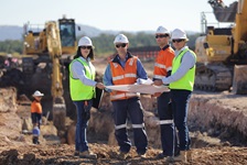 Certification and accreditation 4 people looking at map on development site