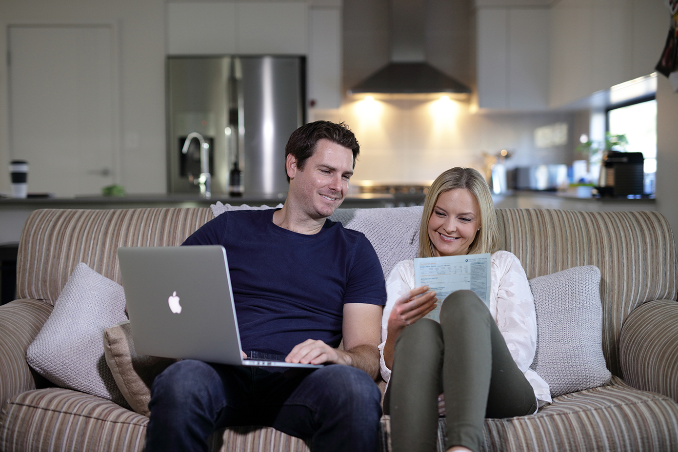 Couple on lounge, e-billing, residential, home