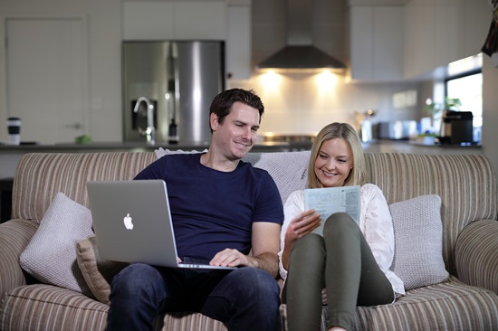 Couple on lounge, e-billing, residential, home
