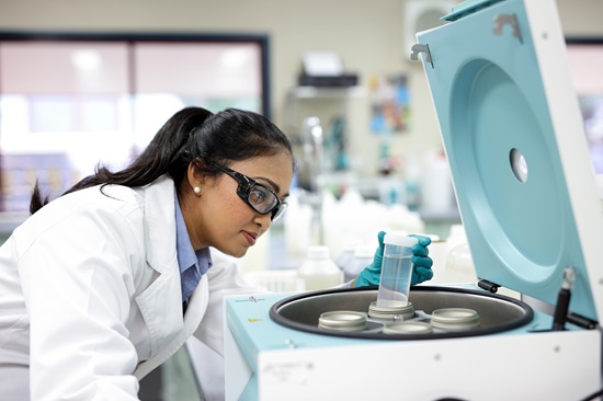 Female laboratory technician looking at test tubes