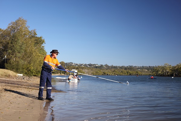 Water tester taking water samples from Maroochy River