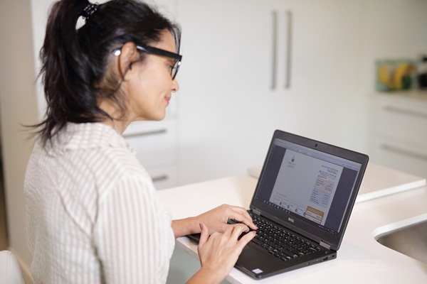 Woman looking an Unitywater bill on laptop computer