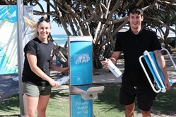 Sam Beattie and Sam Clothier use the Back to Tap refill station at Kings Beach ahead of Caloundra Music Festival.