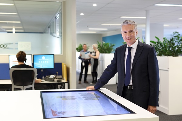 Male staff member operating touch screen in office