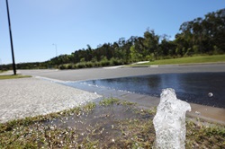 Gushing water leak leak on footpath and public road