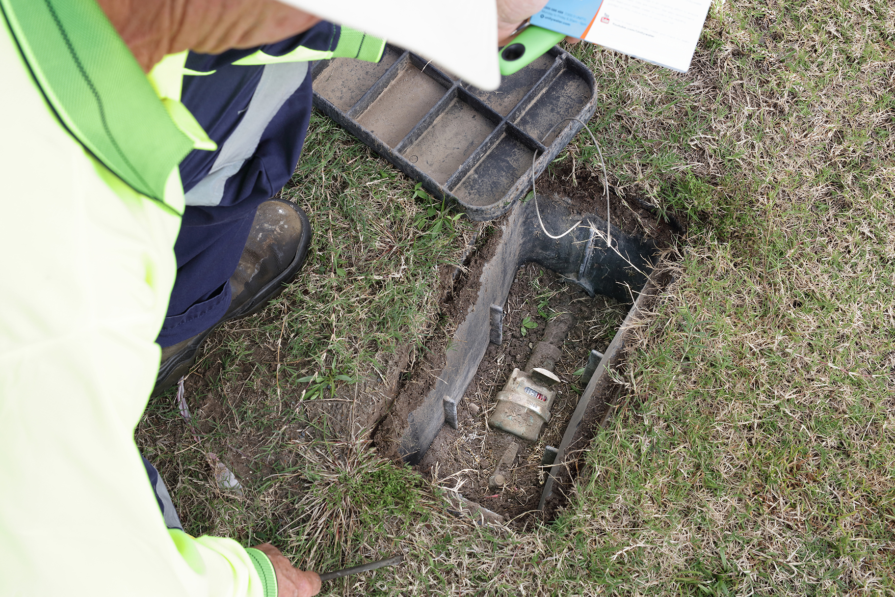Meter Reader looking at residential water meter