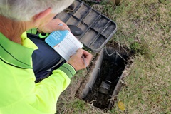 Meter Reader writing meter reading number on Water Meter Reading Notice