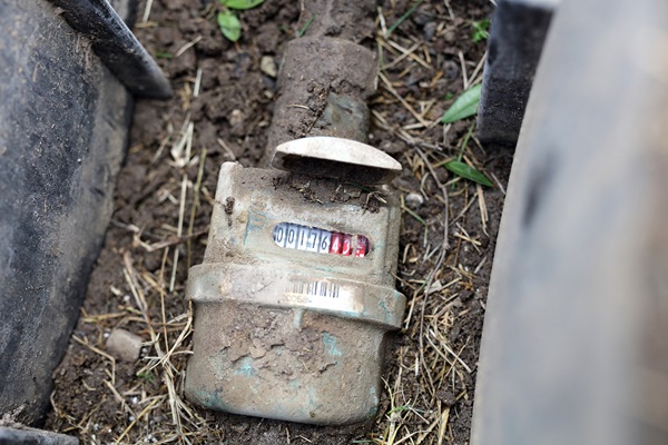 Water meter buried in dirt