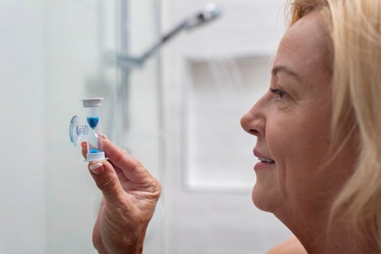 Customer using shower timer to cut down shower time