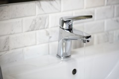 Tap dripping water in residential bathroom sink