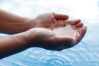 Hands cupping water