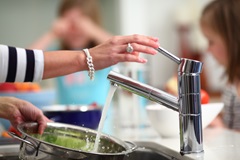 Washing lettuce in kitchen sink