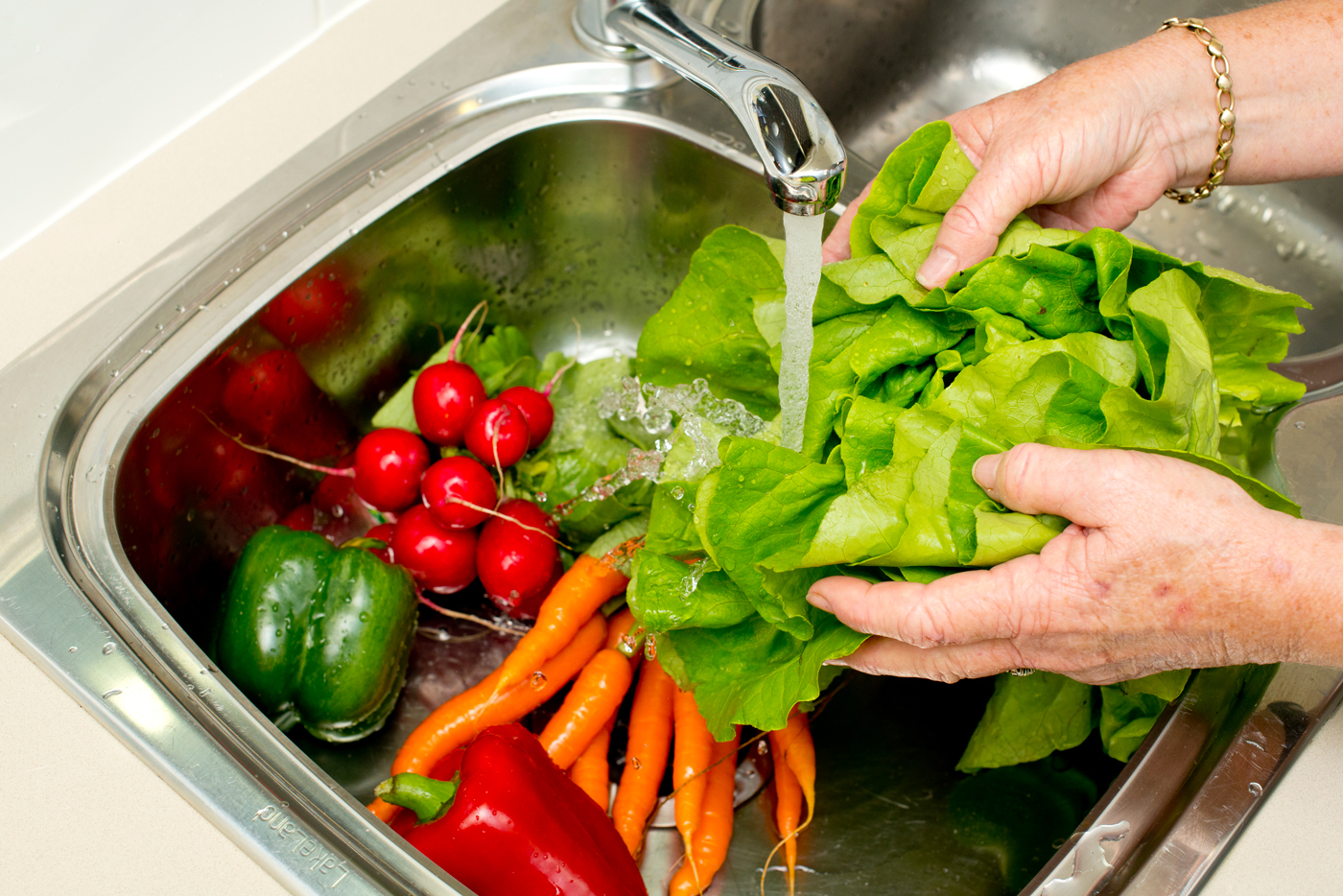 Washing vegetables in kitchen sink