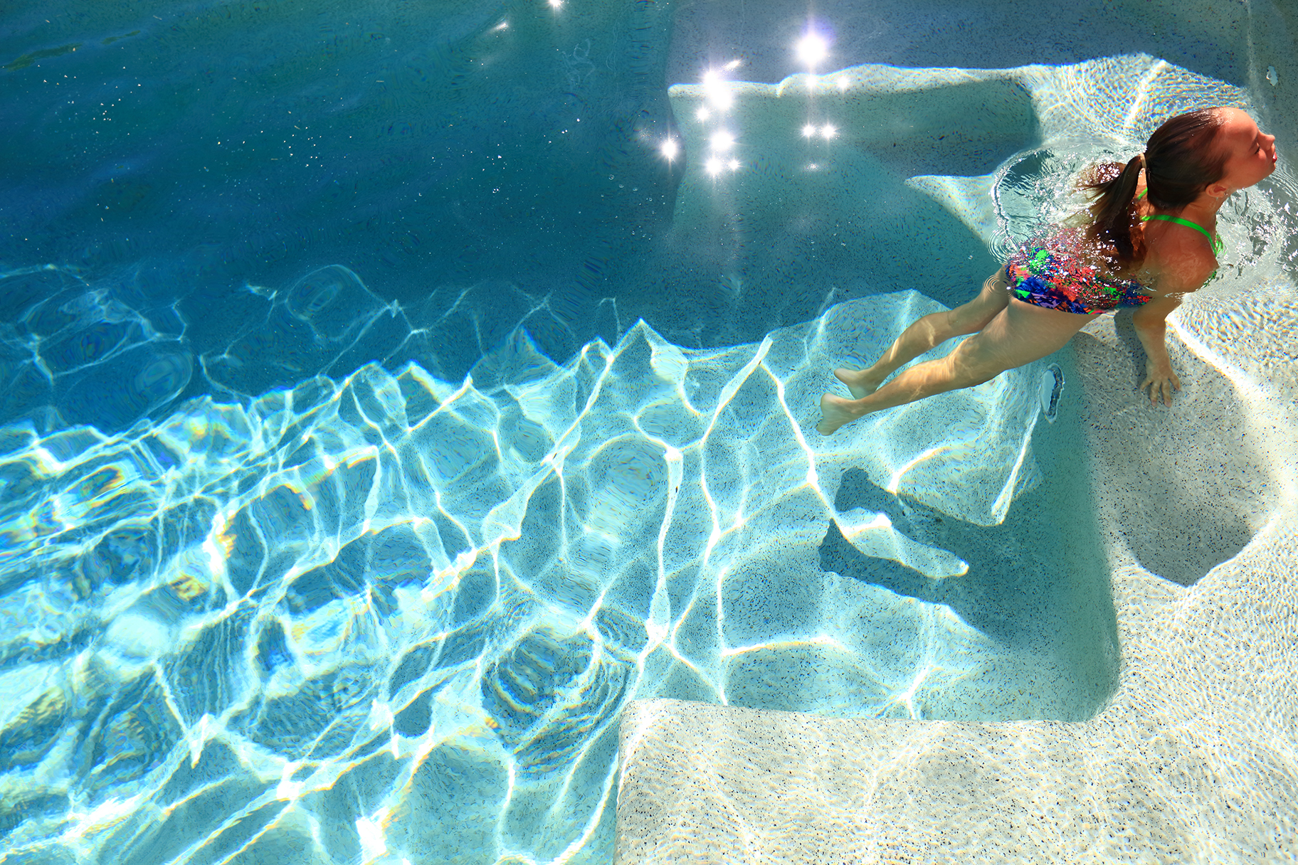 Girl swimming in residential pool